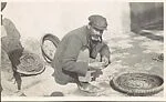 [Man on Street Weaving Basket, Malaga, Spain]