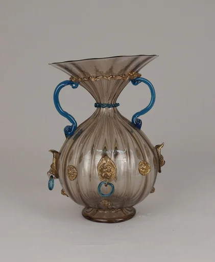 Ribbed and fluted vase with lion masks