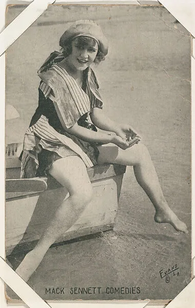 Bathing beauty in costume seated on boat from Mack Sennett Comedies Arcade series (W423) — Unknown