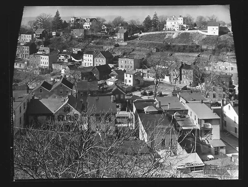 [Main Street and Houses on Hillside with Tree Branches in Foreground, Ossining, New York?]