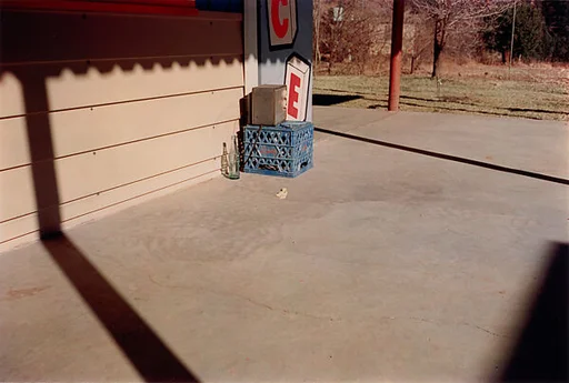 Untitled (Bottle on Cement Porch)