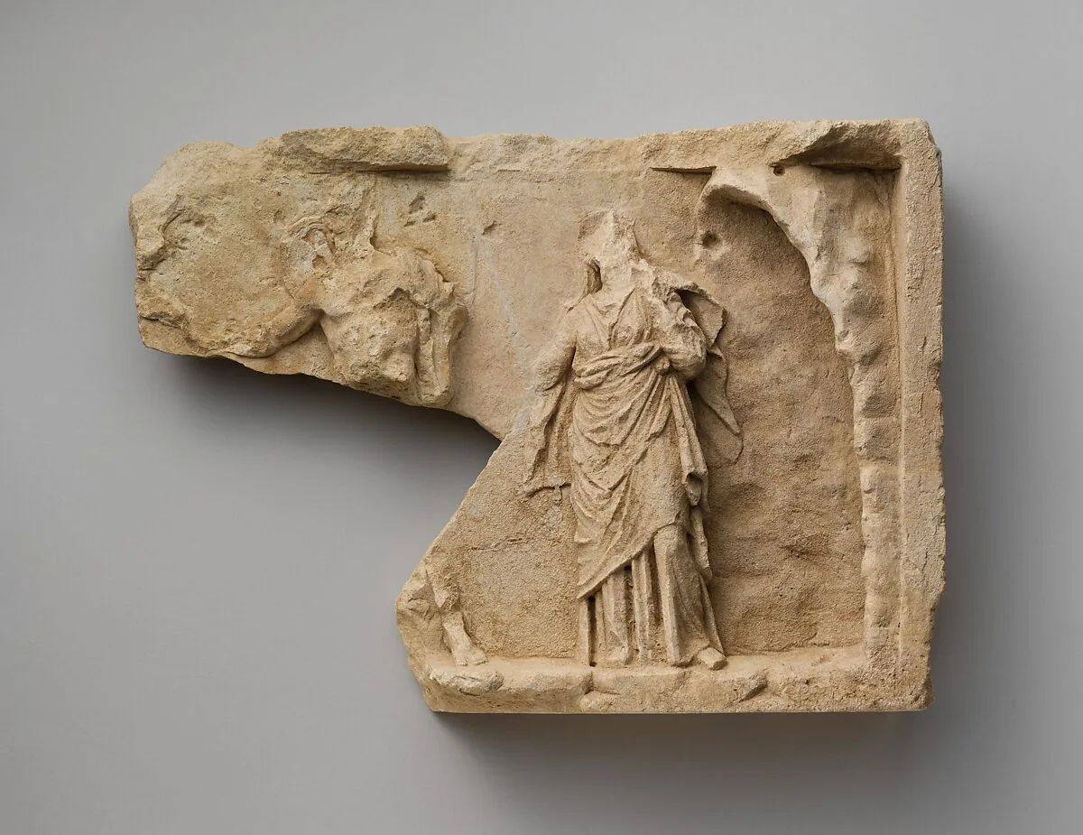 Fragment of a limestone relief with two standing figures — Unknown