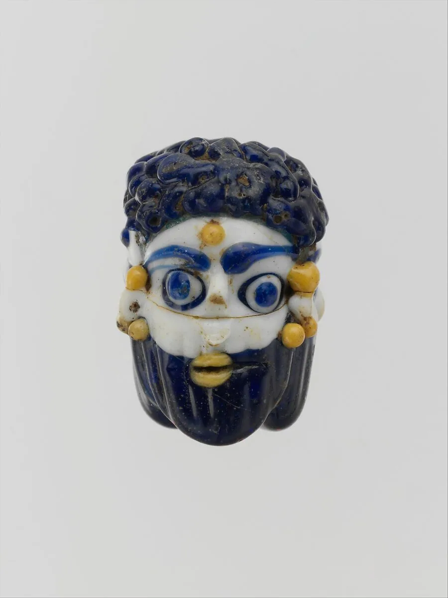 Glass face bead — Unknown
