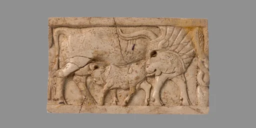 Furniture plaque carved in relief with a cow suckling a calf