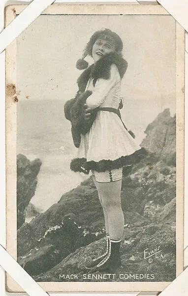 Bathing beauty in costume with fur standing on rocks from Mack Sennett Comedies Arcade series (W423) — Unknown