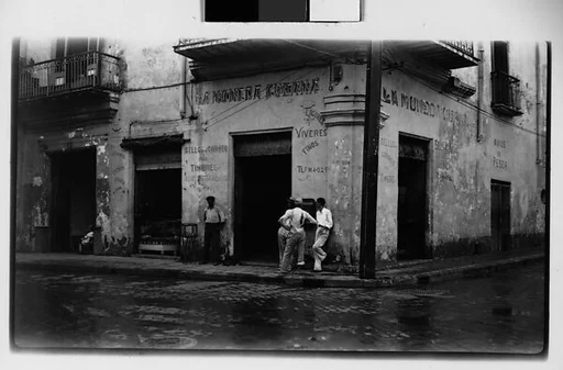 [Men on Street in Front of Restaurant "La Moneda Cubana", Havana]