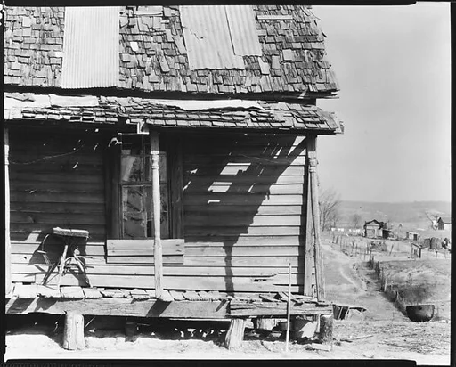 [Porch of Wooden House with Buildings and Clotheslines in Distance, Outskirts of Tupelo, Mississippi]