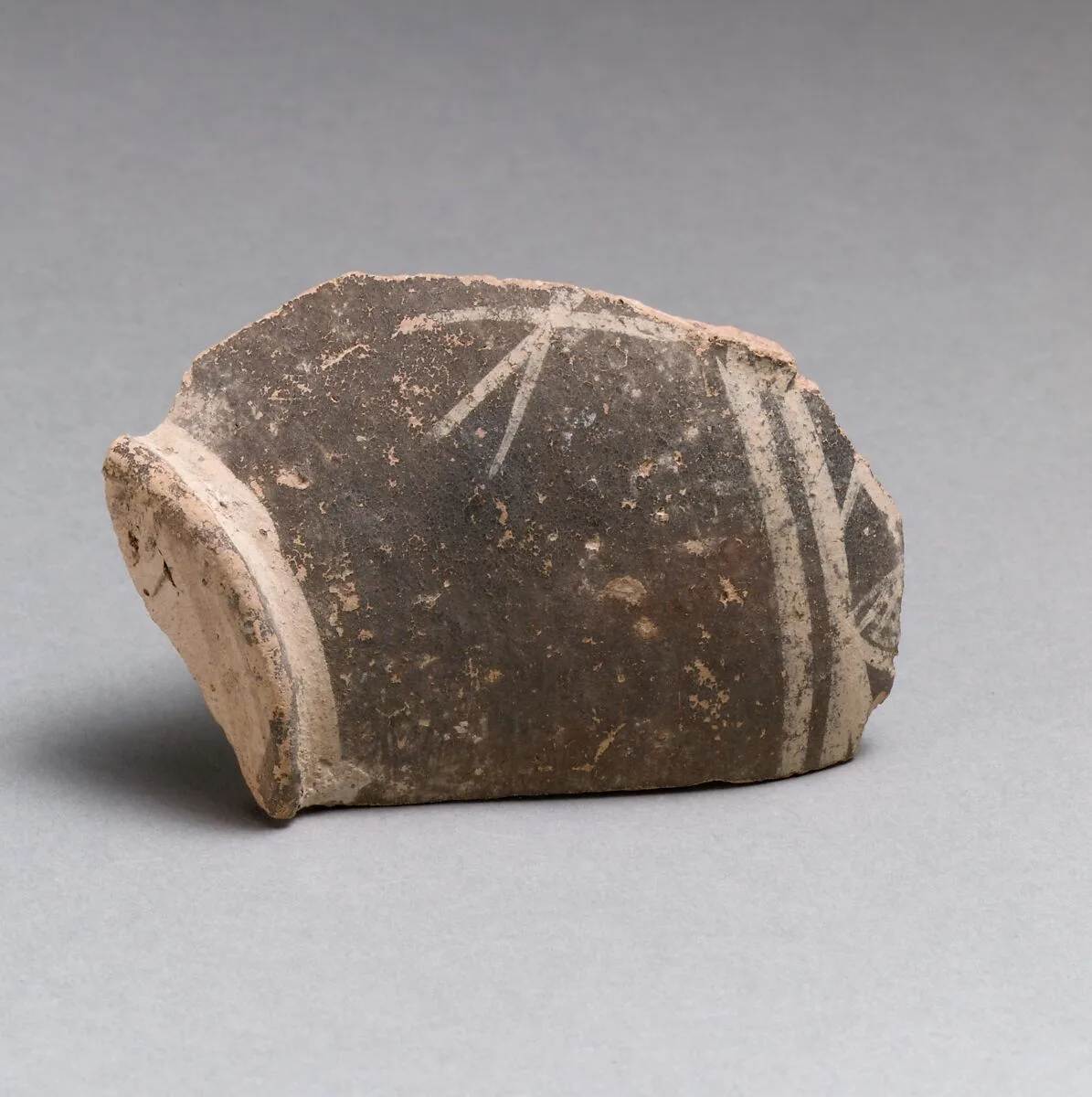 Terracotta base of a small vase with linear decoration — Unknown