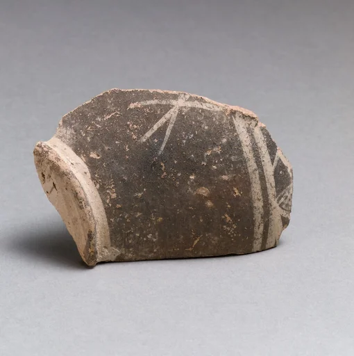 Terracotta base of a small vase with linear decoration