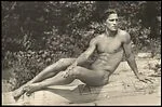 [Nude Male Model Posed on Driftwood at the Beach]