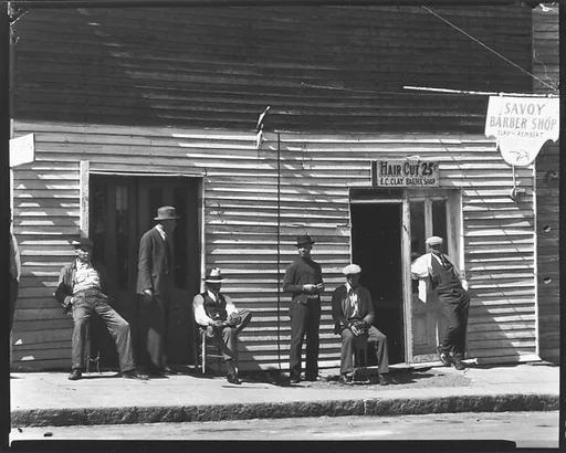 [Men Seated and Standing in Front of Savoy Barber Shop, Vicksburg, Mississippi]