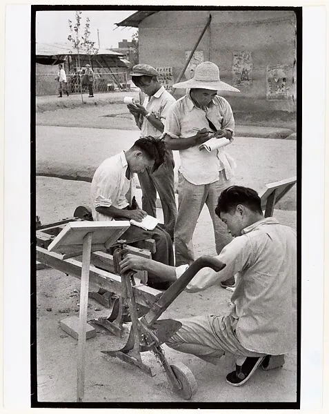 Visitors take notes on a peasant invention at National Farm Implements Exhibit, Peking — Henri Cartier-Bresson