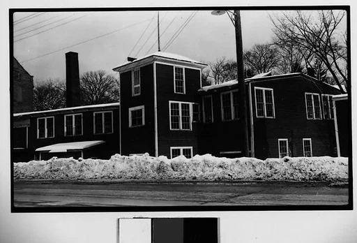 [Wooden Clapboard Building Behind Snow Bank]