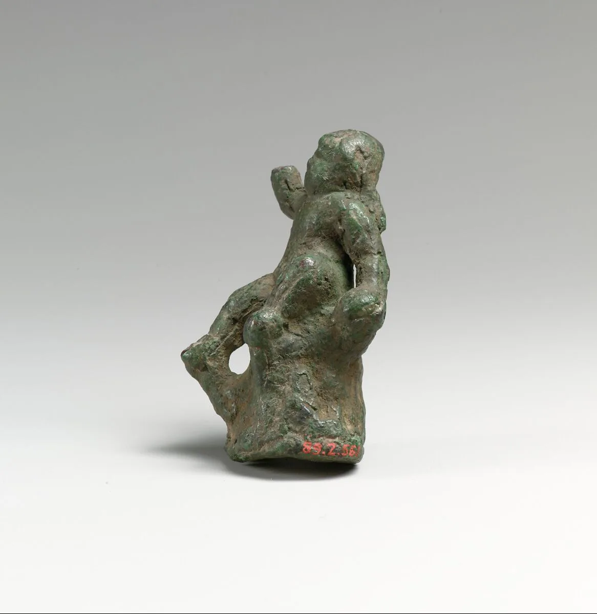 Bronze statuette of Eros seated on a rock — Unknown