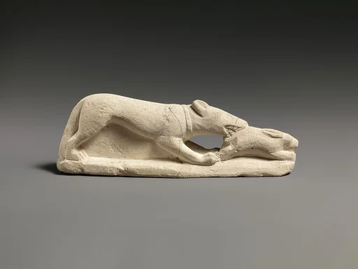 Limestone statuette of a coursing hound seizing a hare