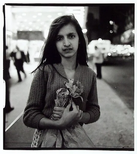 Child selling plastic orchids at night, N.Y.C.