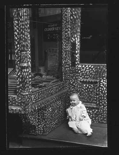 [Doll in Painted Doorway of Cutlery Shop, New York City]