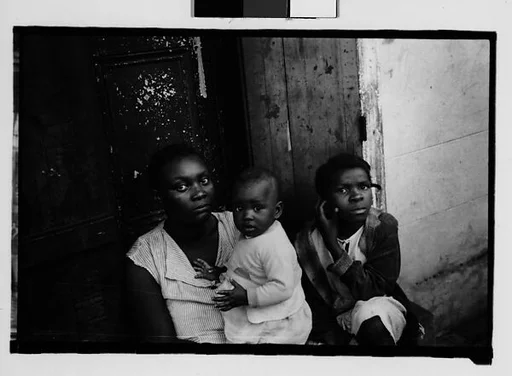 [Mother and Children Seated in French Quarter Doorway, New Orleans, Louisiana]
