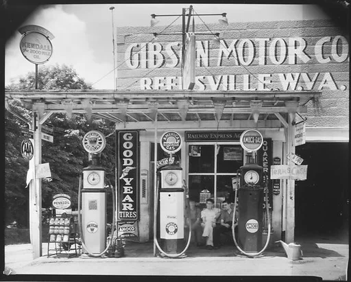 [Gibson Motor Company Gas Station with Group of Men Seated on Bench, Reedsville, West Virginia]
