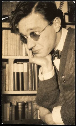 [Self-Portrait, Chin in Hand Wearing Rounded Spectacles in Apartment at 48 Columbia Heights, Brooklyn, New York]