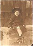 [Walker Evans Wearing Roller Skates, Seated on Stone Wall]