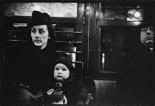 [Three 35mm Film Frames: Subway Passengers, New York City: Mother with Child on Lap]