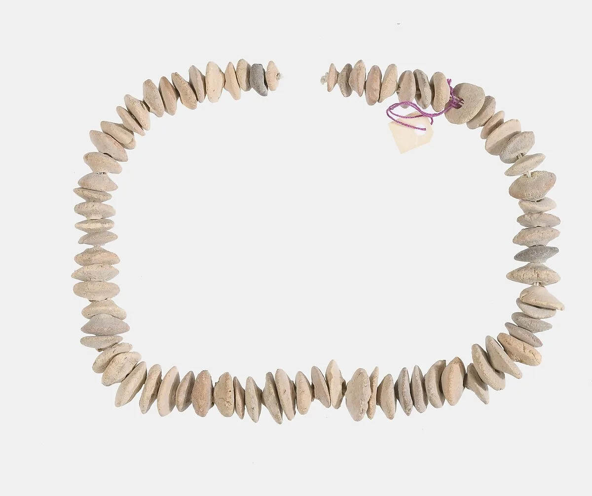 Necklace of white lenticular beads — Unknown