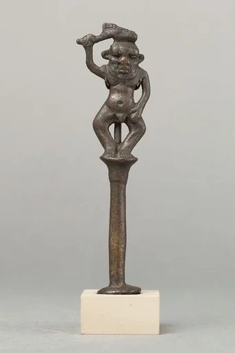 Bes on a column holding a knife