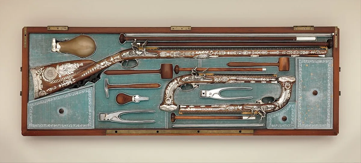 Cased Set of a Flintlock Rifle, a Pair of Pistols, and Accessories — Nicolas Noël Boutet