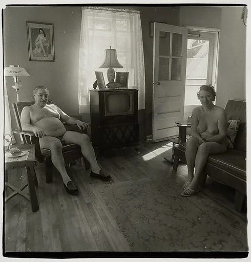Retired man and his wife at home in a nudist camp one morning, N.J.