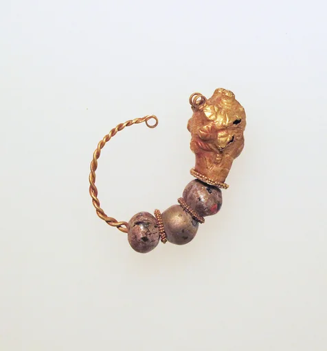 Gold earring with woman's head and glass beads