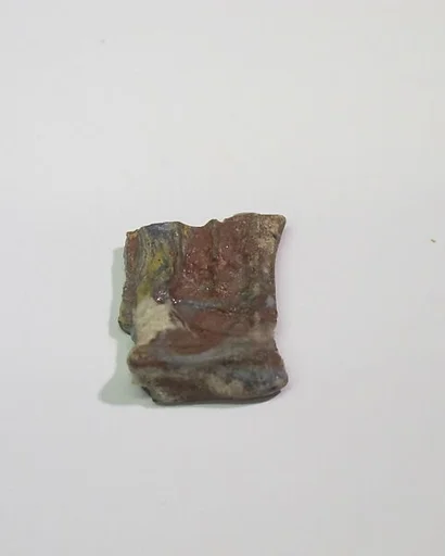 Mold-pressed amulet or fragment