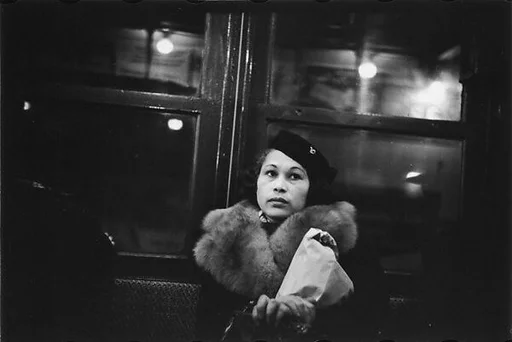 [Four 35mm Film Frames: Subway Passengers, New York City: Woman in Fur Collar with Package, PassengersLying Across Seat, Elderly Man in Hat]