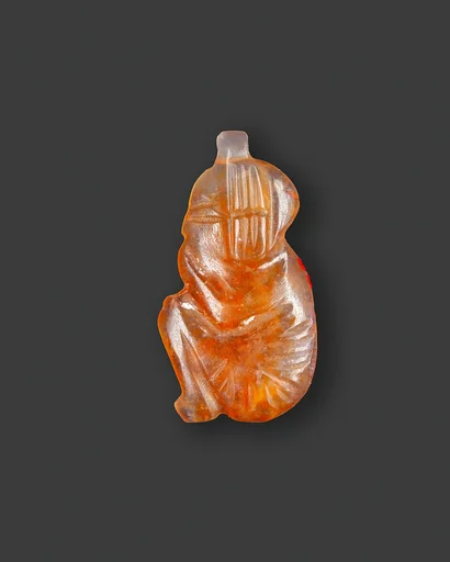 Amulet of a squatting royal male child with the name Usermaatre Ramesses on the underside
