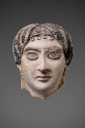 Mask of a woman with radiating waves of hair