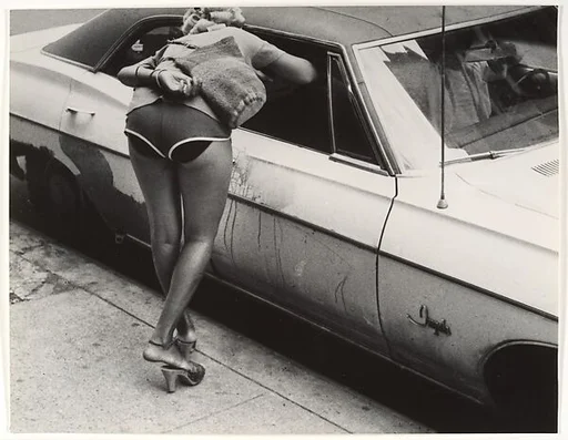 [Street Scene: Woman in Shorts Leaning into Window of Parked Car, New York City]