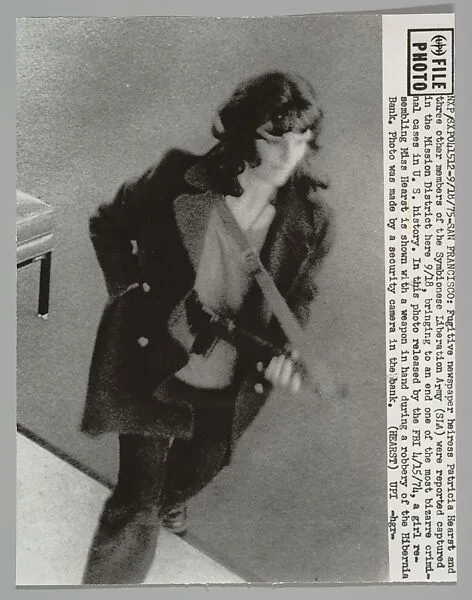 SAN FRANCISCO. Fugitive newspaper heiress Patricia Hearst and three other members of the Symbionese Liberation Army (SLA) were reported captured in the Mission District here 9/18, bringing to an end one of the most bizarre criminal cases in U.S. History. In this photo released by the FBI 4/15/74, a girl resembling Miss Hearst is shown with a weapon in hand during a robbery of the Hibernia Bank — Patricia Hearst|United Press International