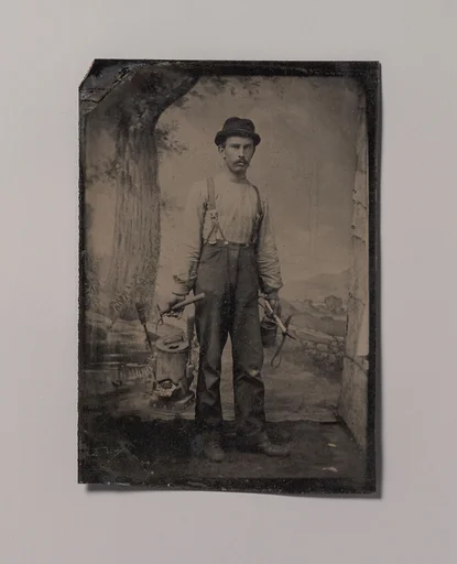 [Tinsmith in Front of Painted Outdoor Backdrop]