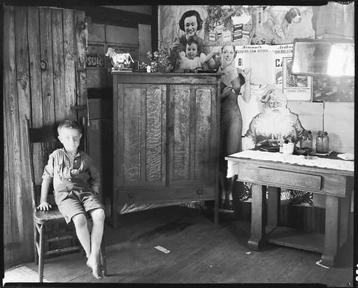[Barefoot Boy in Chair in Coal Miner's House, Vicinity Morgantown, West Virginia]