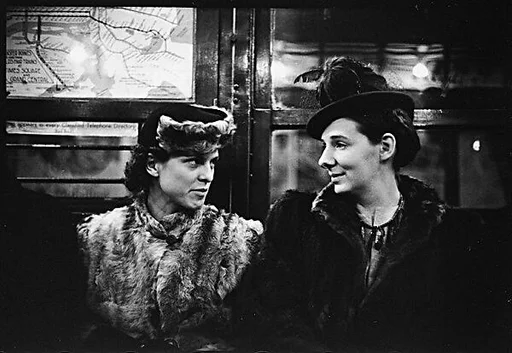 [Five 35mm Film Frames: Subway Passengers, Times Square Shuttle, New York City: Two Women in Conversation, Two Men BeneathShuttle Sign, Woman in Face-Veiled Hat and Boy]