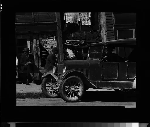 [Street Scene with Parked Car and Men on Sidewalk, Vicksburg, Mississippi]