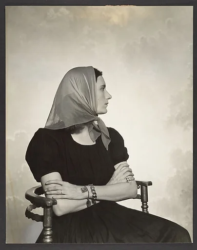 [Woman in Scarf Seated in Chair]