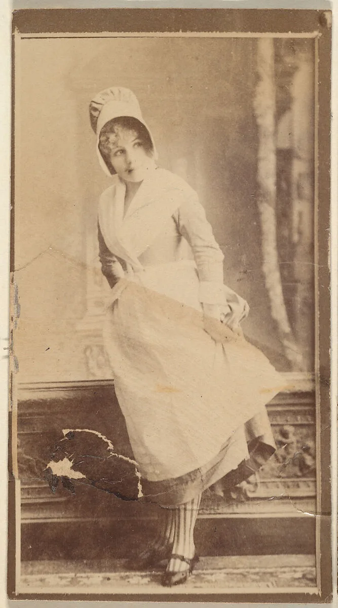 Actress wearing costume with cloth bonnet, from the Actresses series (N668) — Unknown