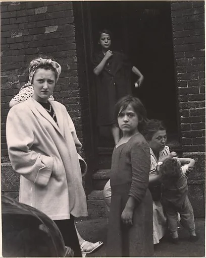 [Group of Women and Children Outside a Doorway]