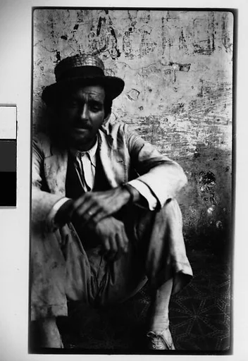 [Man Wearing Boater Seated on Ground, Havana]