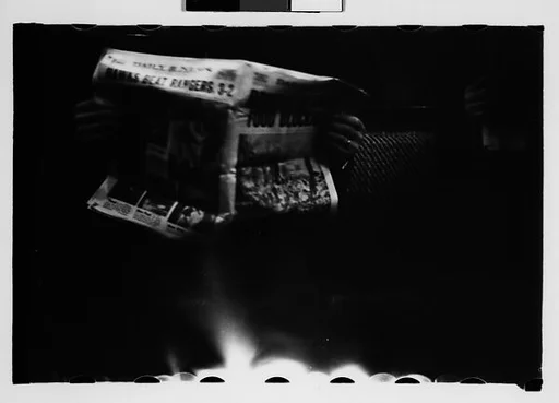 [Four 35mm Film Frames: Subway Passengers, New York City: Man with Newspaper, Woman Holding Package]