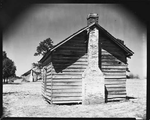 [Side View of Two Wooden Houses]