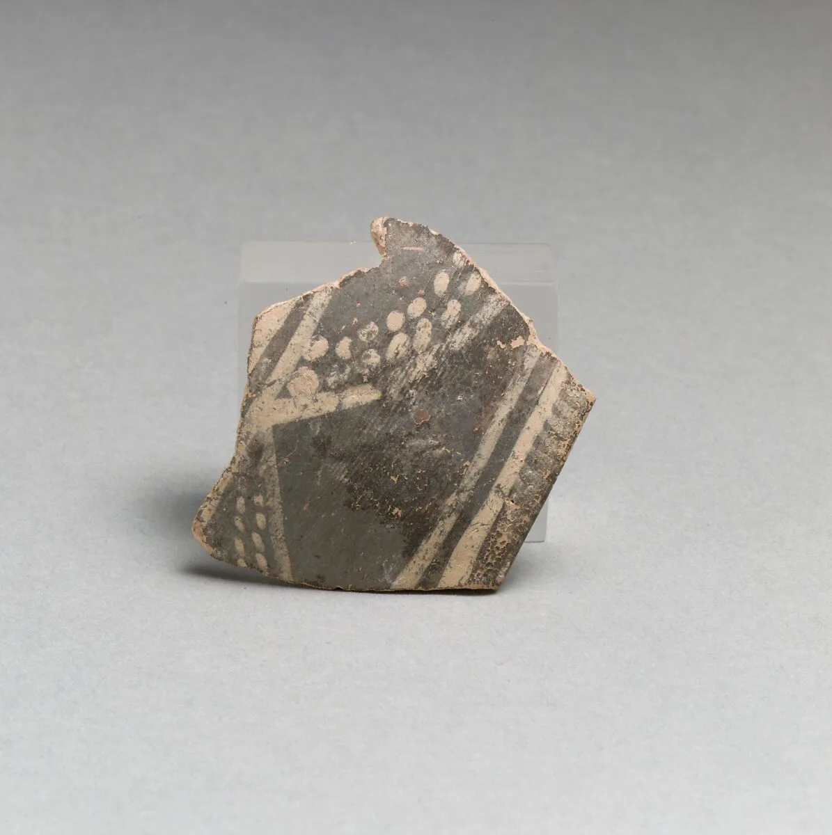 Terracotta rim fragment with bands and dots — Unknown