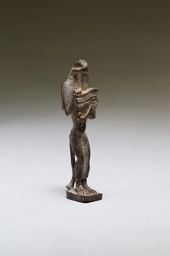 Nehebkau (snake deity) holding a wedjat eye