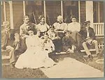 [Group of Eleven Men, Women, and Children, Including Jessie Crane Evans, Theodore H. Crane, Bricena Chadwick Crane, Judith H. Crane, Verner W. Crane, Ronald S. Crane, Ralph Crane, and Robert Crane, Seated on Porch, Gratiot Beach, Michigan]